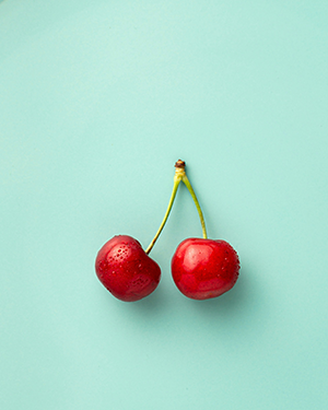 two cherries connected at the stem