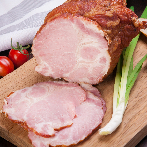 a cooked ham on a cutting board